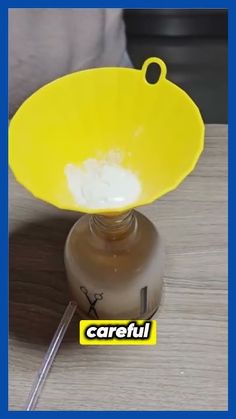 a yellow bowl sitting on top of a wooden table