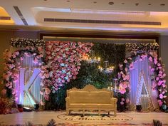 a stage decorated with flowers and greenery