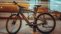 a bicycle is chained to a pole in front of a train