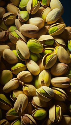 pistachio nuts with green leaves and yellow seeds in the shell, top view