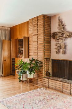 a living room filled with furniture and a large plant on top of a wooden table