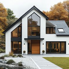 a white house with lots of windows on the front and side of it's roof