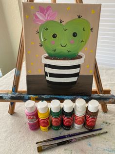 a painting of a cactus in a striped pot with paint and acrylic paints