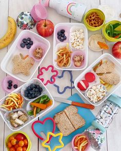 a plastic container filled with different types of snacks and desserts on top of it