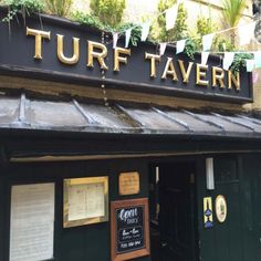 there is a sign that says turff tavern on it