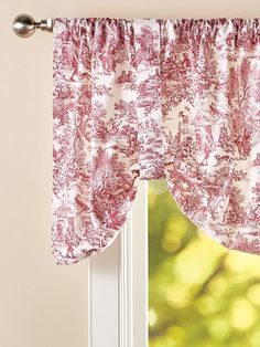 a window with a red and white curtain hanging from it's valance next to a window sill