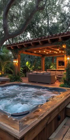 an outdoor hot tub in the middle of a wooden deck with seating and lights around it