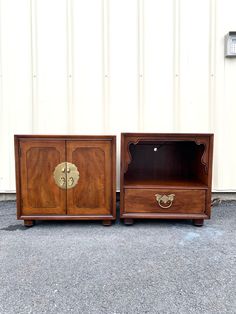 two wooden side tables sitting next to each other in front of a white garage door