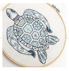 a close up of a cross stitch pattern with a turtle on it's back