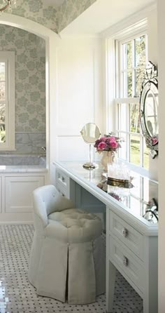 a bathroom with a vanity, tub and chair in it's centerpieces