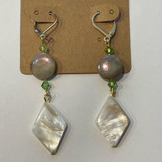 New Handmade Shell Earrings. I Believe Mother Of Pearl Is The Diamond Shaped One, Maybe Abalone Shell For The Round One And Then Green Glass Seed Bead. All On A Gold Tone Hypoallergenic Lever Back Hooks. Hangs About 2-1/4” Long. A Touch Of Power And Touch Of Bling And Iridescence! Handmade Adjustable Pearl White Earrings, Adjustable White Mother Of Pearl Earrings, Adjustable White Crystal Earrings, Elegant Handmade Iridescent Earrings, Elegant Handmade Iridescent Beaded Earrings, Adjustable White Dangle Clip-on Earrings, Boho Tassel Keychain, Tassel Keychain, Long A