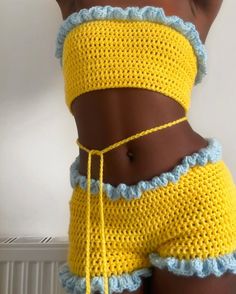 a woman wearing yellow and blue crocheted shorts