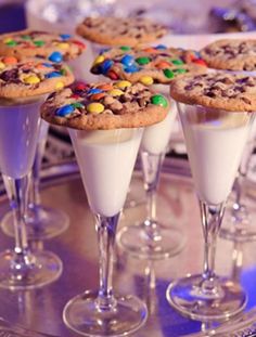 desserts are served in wine glasses on a table