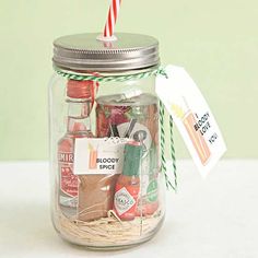 a mason jar filled with assorted condiments and a candy cane