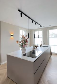 a kitchen with an island, sink and window in the backround is shown