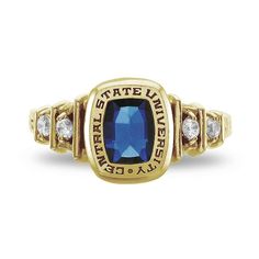 a ring with a blue stone and two diamonds on the sides, set in 18k yellow gold