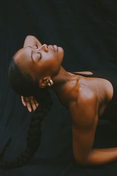 a woman with braids laying on the ground