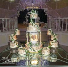 a wedding cake is displayed on a glass table