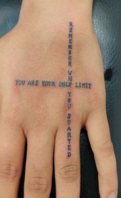 a person's hand with a cross tattoo on it and the words you are your only limit