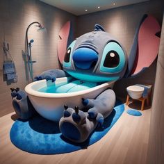 a bathroom with an elephant bathtub and blue rugs on the floor in front of it