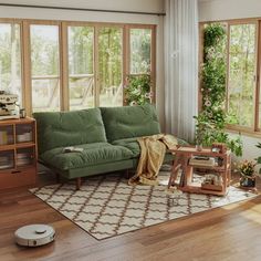 a living room filled with furniture and lots of windows next to a rug on top of a hard wood floor