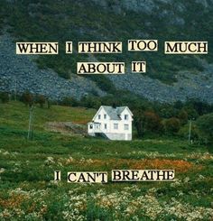 a white house sitting on top of a lush green field next to a mountain with words above it