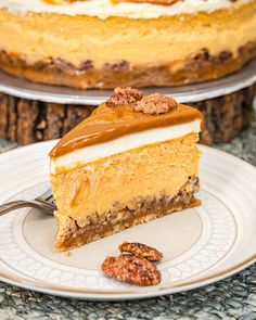 a slice of pumpkin cheesecake with pecans on the side