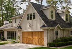 a large house with two garages in front of it