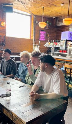 several people sitting at a table in a restaurant