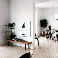 a living room with white walls and wooden floors