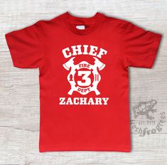 a red t - shirt with the number three on it that says chief fire department