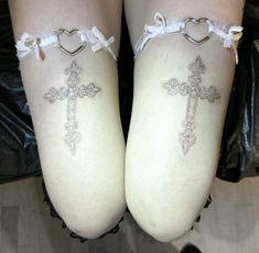 two legs with cross tattoos on them