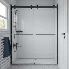 a white tiled bathroom with a walk in shower