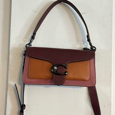 Coach Tabby Shoulder Bag 26 New Missing Tag, Never Used The Color Is Orange/Dark Brownish Red Or Burgandy. Dust Bag Included. Measurements Length: 10.25" Height: 5.5" Width: 2.75" Materials Polished Pebble Leather Leather Lining Strap Detachable Short Strap With 7" Drop Detachable Long Strap With 21" Drop For Shoulder Or Crossbody Wear Features Inside Zip Pocket Snap Closure Inside Multifunction Pocket Smoke-Free Home Brown Rectangular Color Block Shoulder Bag, Brown Color Block Rectangular Shoulder Bag, Coach Burgundy Shoulder Bag With Adjustable Strap, Everyday Color Block Crossbody Bags, Coach Brown Mobile Phone Bag, Coach Purple Bag With Adjustable Strap, Purple Coach Satchel With Detachable Strap, Coach Purple Satchel With Detachable Strap, Coach Purple Crossbody Shoulder Bag