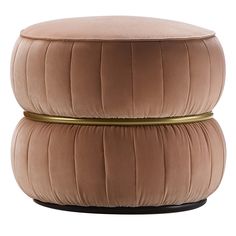 a round ottoman that is made out of velvet