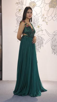 A mix of royal and modern, this long dress in Sea Green colour handcrafted on georgette with multicolour crystal and stripes has an entirely different look because of the jacket. Style this for the classic indo western look.Fabric- georgette with net, work- metal stripes with multicolor crystalOccasion: Wedding ,Cocktail, Family & Pooja,Reception ,EngagementNo. Of Components: 1 Style: Gown Fabric: Georgette Work: Sequin, Cut dana Colour: Sea Green Chest: 36 Note:- Originally Stitched in 36 but c Embellished Georgette Lehenga Maxi Length, Embellished Georgette Lehenga In Maxi Length, Party Lehenga Embellished Maxi Length, Embellished Maxi Length Lehenga For Party, Maxi Length Embellished Lehenga For Party, Glamorous Festive Georgette Dresses, Glamorous Georgette Dresses For Festive Occasions, Hand Embellished Floor-length Georgette Gown, Embellished Party Wear Gown For Party Season