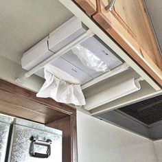 an overhead view of a kitchen stove and oven with paper on the hood above it