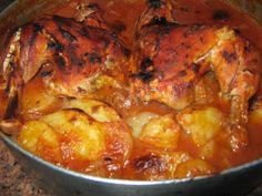 some chicken is cooking in a pot on the stove top and it's ready to be cooked