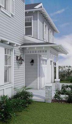 the front of a house with white siding and windows