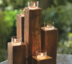 candles are placed in wooden blocks on a table