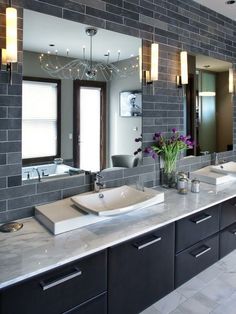 a large bathroom with double sinks and mirrors