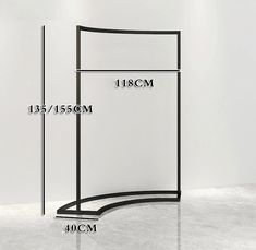 the measurements of a curved metal shelf in front of a white wall with black trim