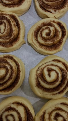 several cinnamon rolls sitting on top of a baking sheet