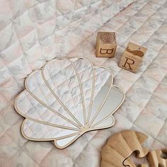 a wooden toy and mirror on a bed