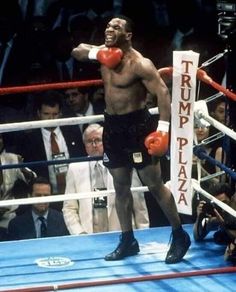 a man standing next to a boxing ring