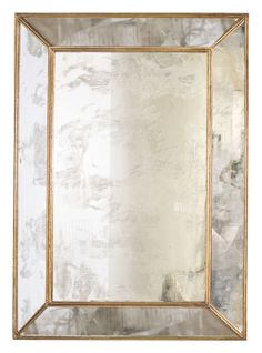 a gold framed mirror on a white wall