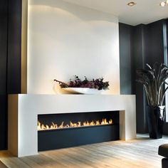 a modern fireplace in the middle of a living room