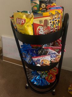 a black cart filled with candy and snacks