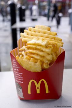 french fries in a red box on a table