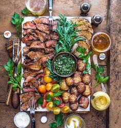 a wooden table topped with meat and veggies